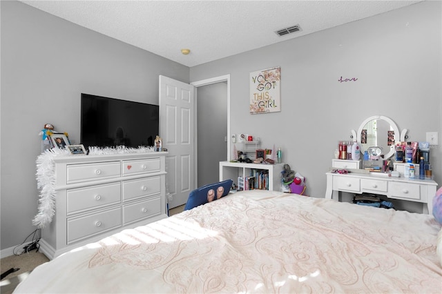 bedroom with a textured ceiling and carpet floors