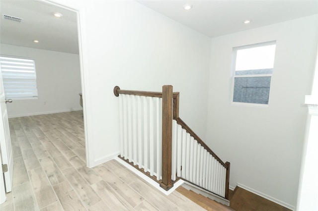 staircase featuring wood-type flooring