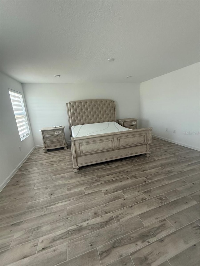 bedroom with hardwood / wood-style flooring