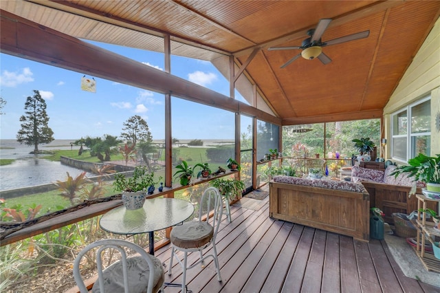 sunroom with ceiling fan, a water view, wooden ceiling, and vaulted ceiling