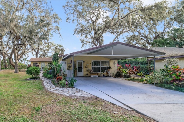 exterior space with a carport and a front yard