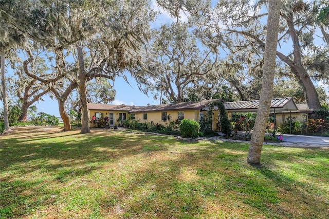 ranch-style home featuring a front yard