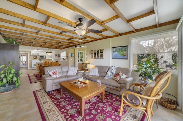 living room featuring light tile patterned floors, ceiling fan, and a healthy amount of sunlight