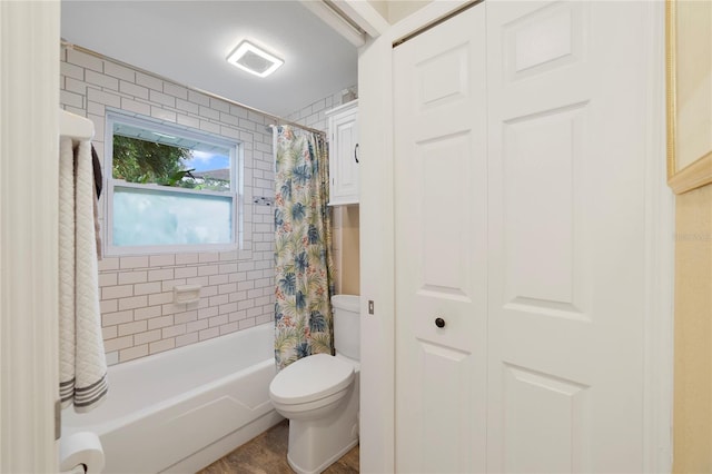 bathroom featuring toilet and shower / bath combo with shower curtain