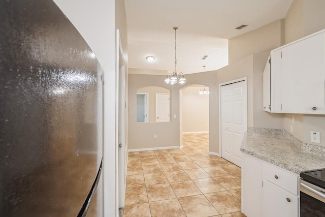 kitchen featuring white cabinetry, a notable chandelier, lofted ceiling, decorative light fixtures, and light tile patterned flooring