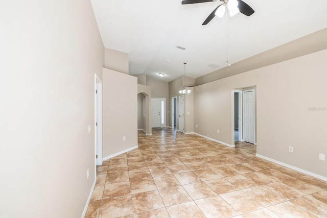 empty room with lofted ceiling and ceiling fan with notable chandelier