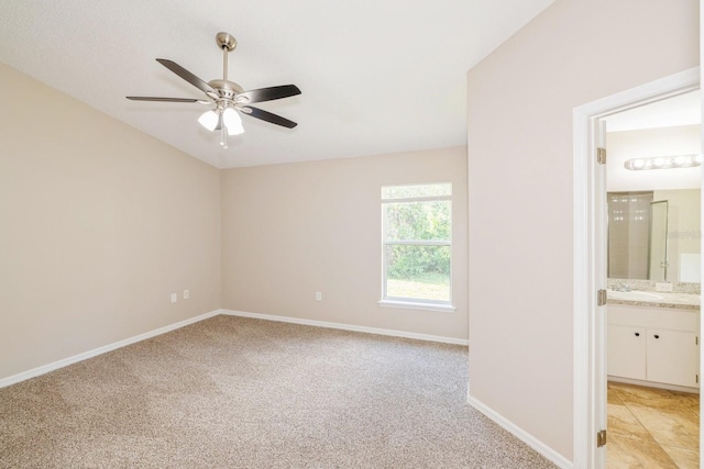 carpeted spare room with ceiling fan and sink