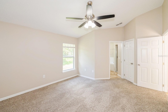 unfurnished bedroom featuring ceiling fan, light colored carpet, and vaulted ceiling