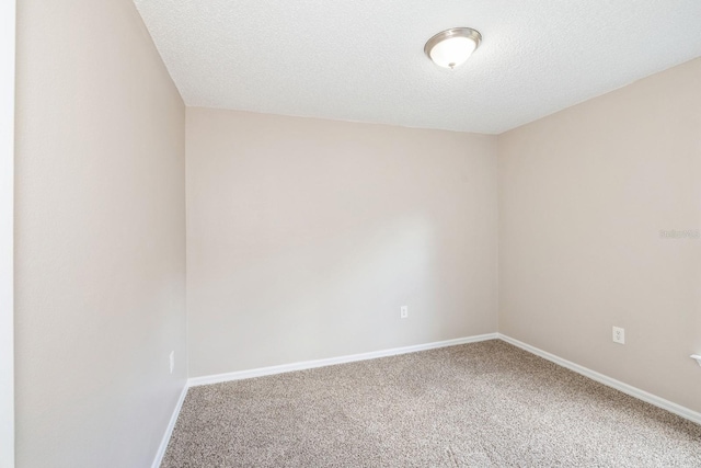 carpeted spare room with a textured ceiling