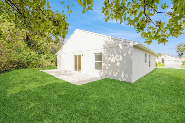 back of property with a lawn and a patio area