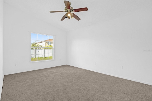 spare room featuring carpet flooring, ceiling fan, and lofted ceiling