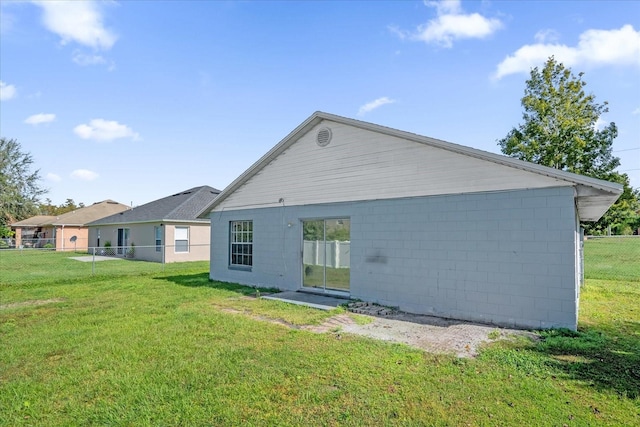 rear view of house featuring a yard