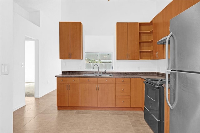 kitchen featuring electric range, stainless steel fridge, and sink