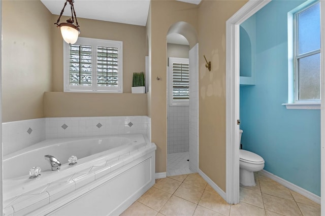 bathroom featuring tile patterned floors, plus walk in shower, and toilet