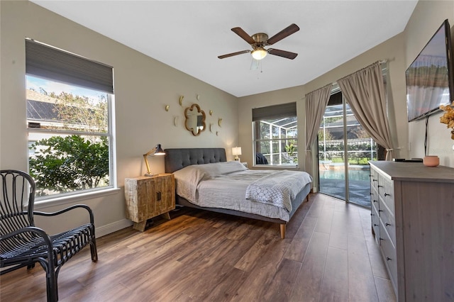 bedroom featuring dark wood-type flooring, access to outside, and ceiling fan