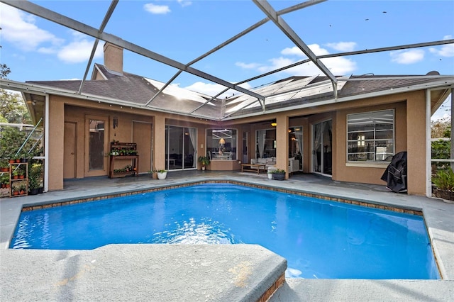 view of pool with a patio and glass enclosure