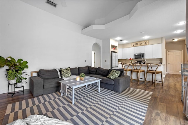 living room with dark hardwood / wood-style flooring