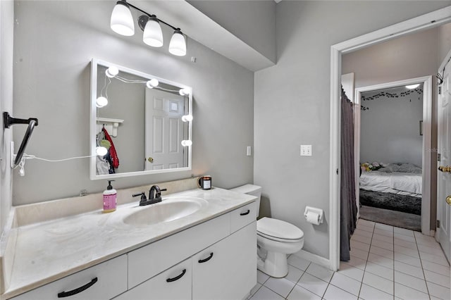 bathroom featuring vanity, tile patterned floors, and toilet