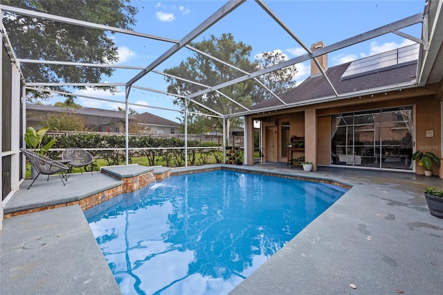 view of swimming pool featuring pool water feature, a patio area, and glass enclosure