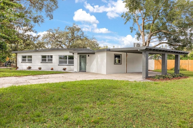 view of front of property with a carport and a front lawn