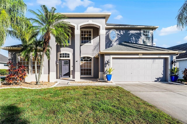 view of front of property featuring a garage and a front lawn