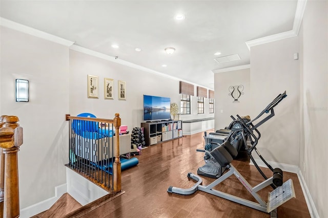 exercise room featuring hardwood / wood-style flooring and ornamental molding