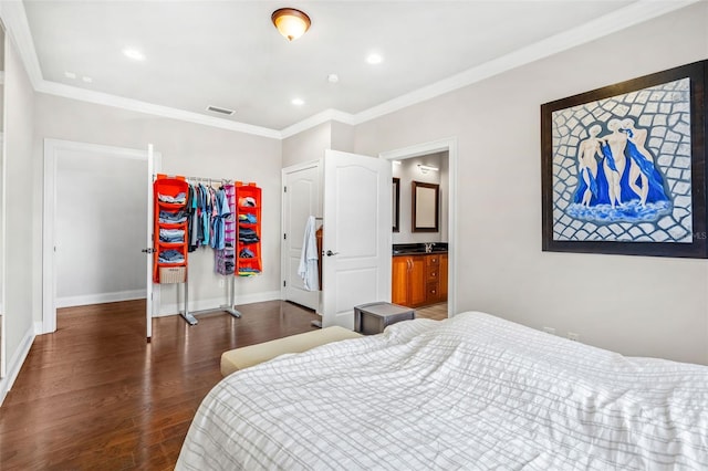 bedroom featuring dark hardwood / wood-style flooring, crown molding, and a closet