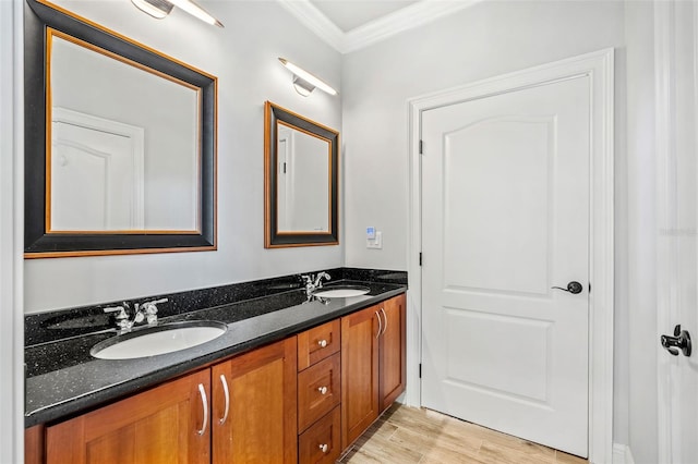 bathroom featuring crown molding, hardwood / wood-style floors, and vanity