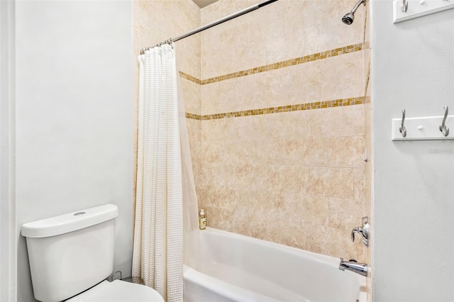 bathroom featuring toilet and shower / bath combo with shower curtain