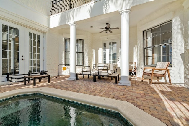 exterior space with french doors, an outdoor living space, ceiling fan, and a patio area