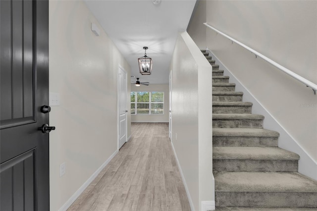 stairway with hardwood / wood-style flooring