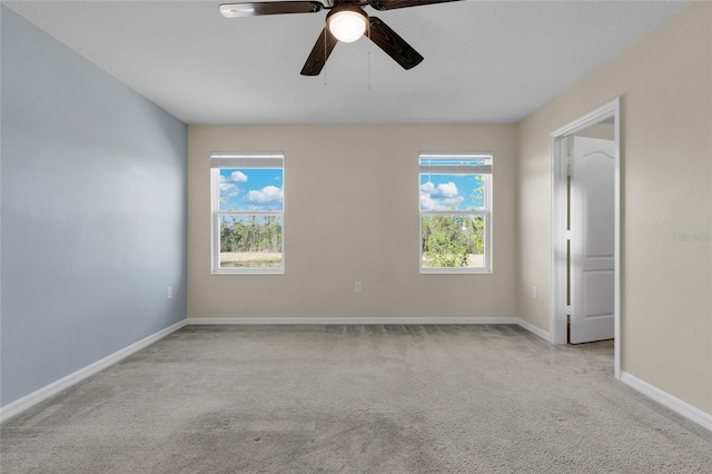 empty room with light carpet and ceiling fan