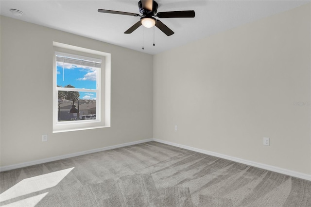 empty room featuring light carpet and ceiling fan