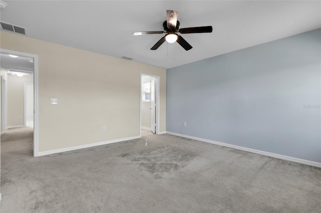 unfurnished room featuring light colored carpet and ceiling fan