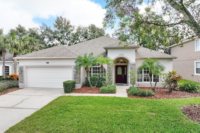 view of front of house with a front yard and a garage