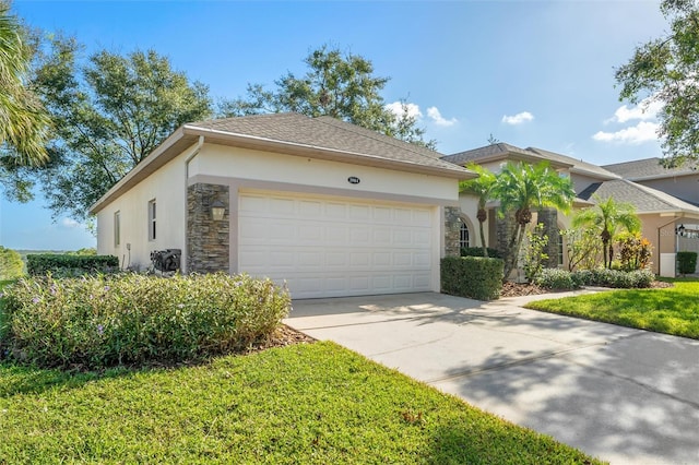 view of front of property featuring a garage and a front lawn