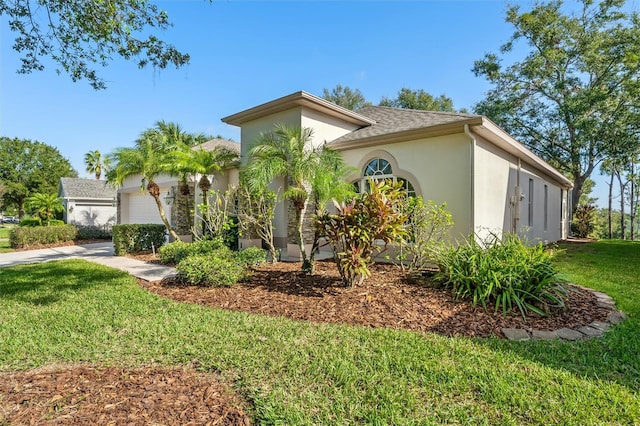 mediterranean / spanish house with a garage and a front lawn