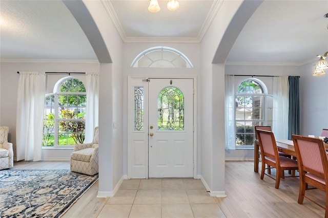 entryway featuring light hardwood / wood-style floors and ornamental molding