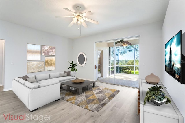 living room featuring ceiling fan and light hardwood / wood-style flooring