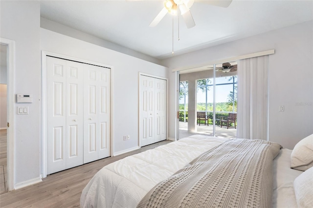 bedroom featuring two closets, light wood-type flooring, access to outside, and ceiling fan