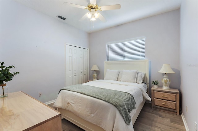 bedroom with a closet, ceiling fan, and dark hardwood / wood-style flooring