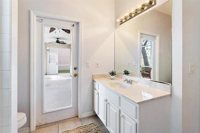 bathroom with toilet, vanity, tile patterned floors, and ceiling fan