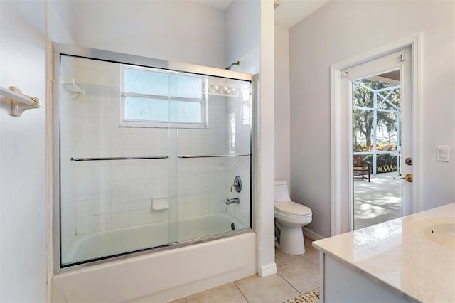 full bathroom featuring tile patterned flooring, vanity, enclosed tub / shower combo, and toilet