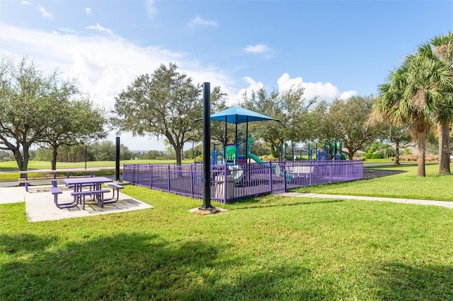 view of playground with a lawn