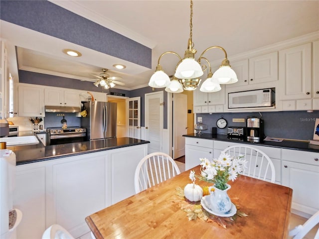 dining space featuring ceiling fan and ornamental molding