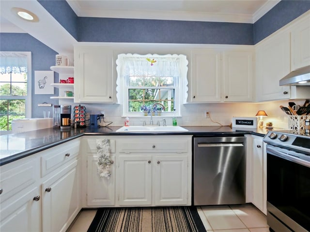 kitchen with white cabinets, appliances with stainless steel finishes, a healthy amount of sunlight, and sink