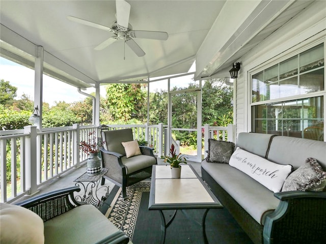 sunroom featuring ceiling fan and plenty of natural light