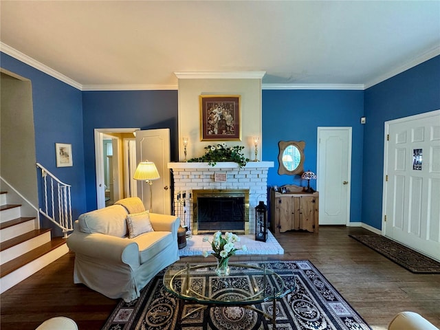 living room with ornamental molding, dark wood-type flooring, and a brick fireplace