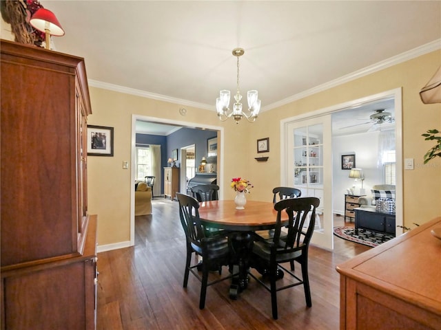 dining space featuring crown molding, ceiling fan with notable chandelier, and dark hardwood / wood-style floors