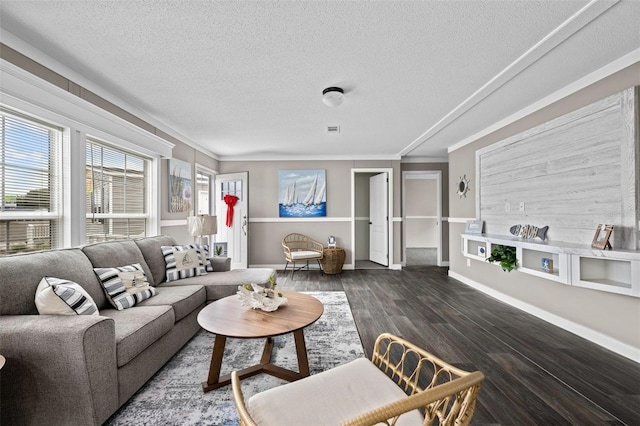 living room featuring crown molding, dark hardwood / wood-style flooring, and a textured ceiling